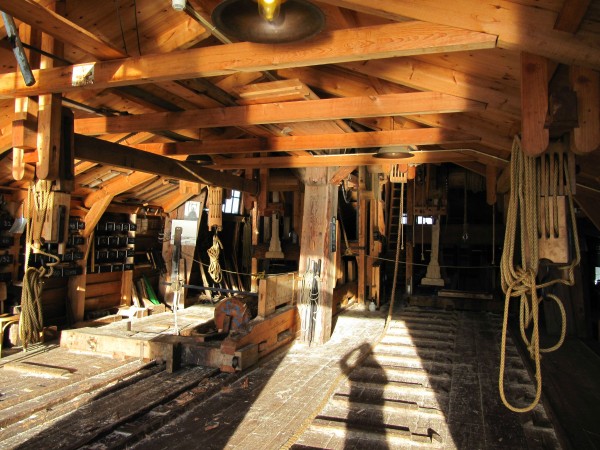 A look inside the mill. A log is waiting to be sawn into boards on the sled next to the support beam.